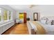 Inviting primary bedroom with sunny windows, hardwood floors, and a cozy seating area at 3811 E 26Th Avenue Pkwy, Denver, CO 80205