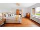 Bright main bedroom boasts hardwood floors, large windows, and stylish furnishings at 3811 E 26Th Avenue Pkwy, Denver, CO 80205