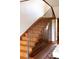Classic staircase with wood steps, iron railings, and paneled walls, showcasing traditional design at 3811 E 26Th Avenue Pkwy, Denver, CO 80205