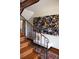 Elegant staircase with wood steps, iron railing, and decorative wall art at 3811 E 26Th Avenue Pkwy, Denver, CO 80205