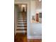 View of wooden staircase leading to the upper level, next to the kitchen area with a countertop at 3811 E 26Th Avenue Pkwy, Denver, CO 80205