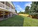 Expansive backyard featuring a lush lawn, mature trees, wooden fence and covered patio at 7629 S Fillmore Way, Centennial, CO 80122