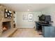 Cozy basement with stone fireplace, custom shelving, and a workspace setup at 7629 S Fillmore Way, Centennial, CO 80122