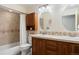 Well-lit bathroom with a double sink vanity, medicine cabinet, and a shower-tub combination at 7629 S Fillmore Way, Centennial, CO 80122