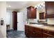 Bathroom with stone floors, dark cabinets, and a view to the backyard at 7629 S Fillmore Way, Centennial, CO 80122