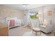 Charming Bedroom featuring daisy wallpaper, white crib, and tent for playtime at 7629 S Fillmore Way, Centennial, CO 80122