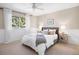 Bright bedroom featuring a ceiling fan and a large window with views of the trees outside at 7629 S Fillmore Way, Centennial, CO 80122