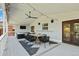 Outdoor deck with comfortable seating, dining area, ceiling fan, and stylish lighting for entertaining at 7629 S Fillmore Way, Centennial, CO 80122