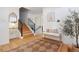 Inviting entryway with wooden floors, staircase, console table, and stylish decor creates a warm welcome at 7629 S Fillmore Way, Centennial, CO 80122