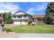 Charming two-story home with a well-manicured lawn, three-car garage and beautiful landscaping at 7629 S Fillmore Way, Centennial, CO 80122