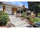 Charming front exterior with well-manicured landscaping, stone pathway, and inviting entryway at 7629 S Fillmore Way, Centennial, CO 80122