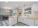 Modern kitchen boasts white cabinets, stainless steel appliances, and butcher block countertops at 7629 S Fillmore Way, Centennial, CO 80122