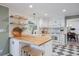 Bright kitchen featuring white cabinets, butcher block countertops, and stylish checkered floors at 7629 S Fillmore Way, Centennial, CO 80122