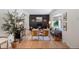 Bright living room with hardwood floors, a modern fireplace, and a large window providing natural light at 7629 S Fillmore Way, Centennial, CO 80122
