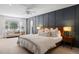 Large main bedroom featuring a board and batten accent wall, fan and sitting area at 7629 S Fillmore Way, Centennial, CO 80122