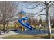 A public playground with colorful blue slide, swing set, picnic tables and a rubber floor at 7629 S Fillmore Way, Centennial, CO 80122