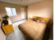 A bedroom features neutral walls, carpet, and a window providing natural light at 227 Powderhorn Trl, Broomfield, CO 80020