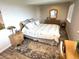 Bright bedroom featuring wood look floors, natural wood furniture, and natural light at 227 Powderhorn Trl, Broomfield, CO 80020