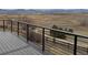 An expansive deck with metal railings provides scenic views of the landscape at 227 Powderhorn Trl, Broomfield, CO 80020