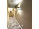 Hallway with wood-look flooring, warm paint, and modern wall sconces at 227 Powderhorn Trl, Broomfield, CO 80020