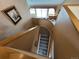 A home staircase featuring neutral carpet, light walls, and a picture frame at 227 Powderhorn Trl, Broomfield, CO 80020