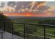 Balcony view of sunset over green fields with mountain views at 227 Powderhorn Trl, Broomfield, CO 80020