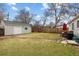 Spacious backyard featuring a detached garage, lush lawn, and a patio area for outdoor dining at 3244 S Holly St, Denver, CO 80222