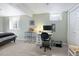 Basement bedroom or office features dual pane windows, neutral walls and carpeted floor at 3244 S Holly St, Denver, CO 80222