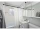 Clean bathroom with tiled tub/shower, vanity, and neutral decor at 3244 S Holly St, Denver, CO 80222