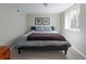 Cozy bedroom with a comfortable bed, neutral walls and a carpeted floor at 3244 S Holly St, Denver, CO 80222