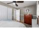 Bedroom with hardwood floors, dresser, closet, and adjoining bathroom at 3244 S Holly St, Denver, CO 80222