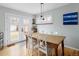 Bright dining area with hardwood floors, modern lighting, and access to the backyard at 3244 S Holly St, Denver, CO 80222