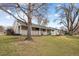 Inviting one-story home with a covered porch and swing, surrounded by a well-maintained lawn at 3244 S Holly St, Denver, CO 80222