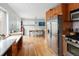 Bright eat-in kitchen features stainless steel appliances and natural wood cabinetry at 3244 S Holly St, Denver, CO 80222