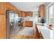 Kitchen with stainless steel appliances, light wood cabinets, and hardwood floors at 3244 S Holly St, Denver, CO 80222