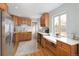 Bright kitchen features stainless appliances and light colored wood cabinets at 3244 S Holly St, Denver, CO 80222