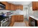 Updated kitchen with stainless appliances, white countertops, and warm wood cabinets at 3244 S Holly St, Denver, CO 80222