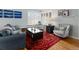 Bright and airy living room featuring plantation shutters, hardwood floors, and comfortable furnishings at 3244 S Holly St, Denver, CO 80222