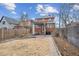 Backyard showing a full brick exterior with a pergola and a partial fence at 1939 W 39Th Ave, Denver, CO 80211