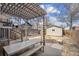 Backyard featuring a pergola-covered dining area, stone patio, and a storage shed at 1939 W 39Th Ave, Denver, CO 80211