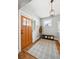 Inviting foyer with a decorative door, a bench, and coat rack on hardwood floors at 1939 W 39Th Ave, Denver, CO 80211