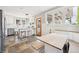 Kitchen area with tile floors, a breakfast bar, lots of windows, stainless steel appliances, and a built in booth at 1939 W 39Th Ave, Denver, CO 80211