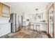 Spacious kitchen featuring stainless steel appliances, a butcher block island, tile floors, and bright white cabinets at 1939 W 39Th Ave, Denver, CO 80211