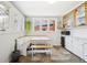 Charming kitchen area with built in booth, lots of windows, and tile floors, and storage at 1939 W 39Th Ave, Denver, CO 80211