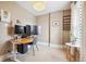 Home office with multiple monitors, a standing desk, and natural light from a nearby window at 1939 W 39Th Ave, Denver, CO 80211