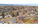 Expansive aerial view of a quiet neighborhood with mountain views and mature trees at 5862 Owens St, Arvada, CO 80004