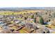 Scenic aerial view showcasing a charming neighborhood with a sports field and tree-lined streets at 5862 Owens St, Arvada, CO 80004