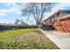 Large backyard featuring a lawn, mature trees, fencing and elevated back patio at 5862 Owens St, Arvada, CO 80004