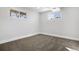 Finished basement area with neutral carpet, painted walls, and two windows allowing for natural light at 5862 Owens St, Arvada, CO 80004