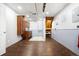 Unfinished basement area with dark wood floor, stairs and a storage area with cabinets at 5862 Owens St, Arvada, CO 80004